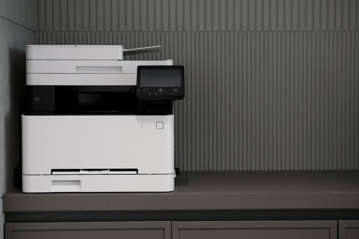 a white and black printer sitting on top of a counter